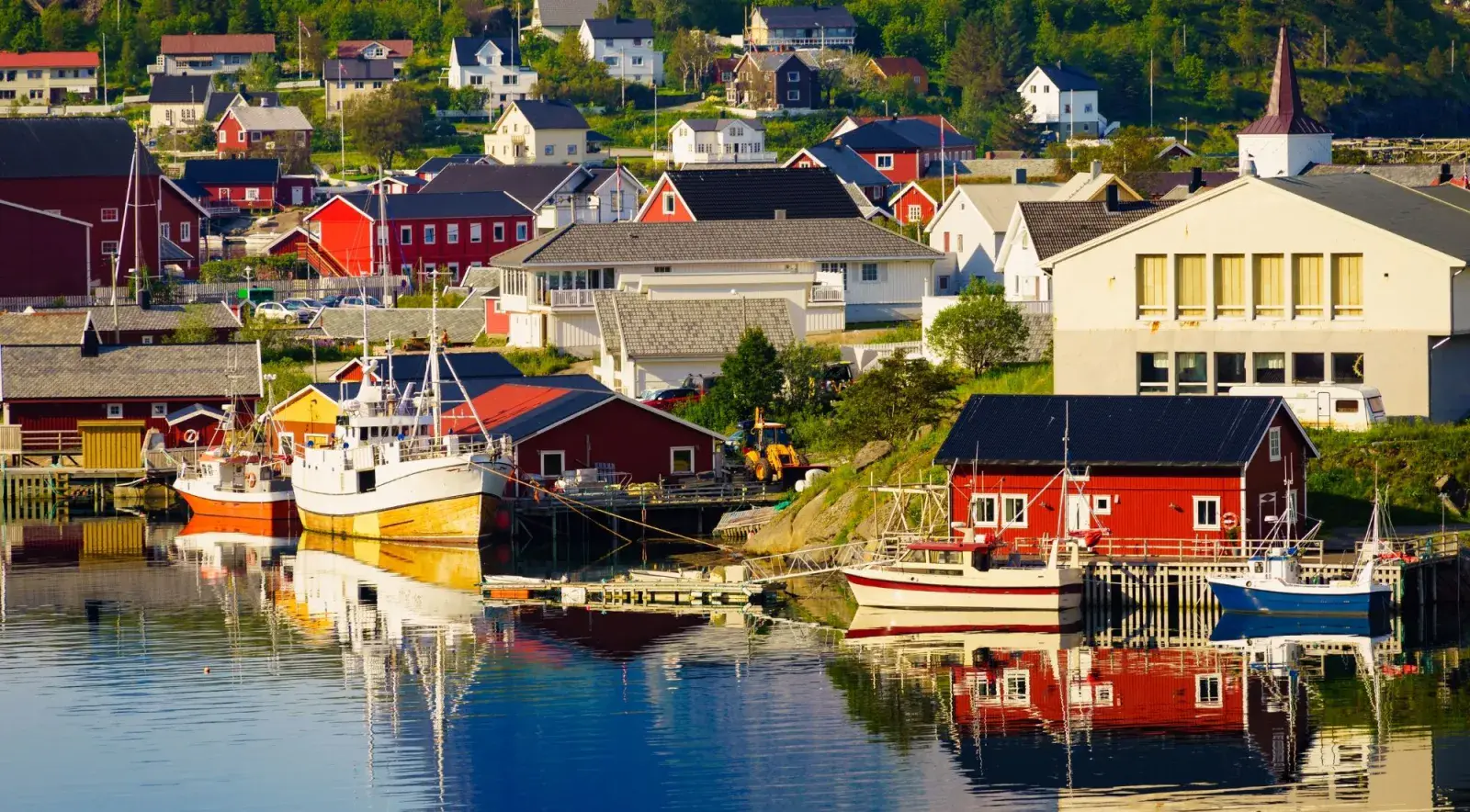 Red and white cabins around a calm Lofoten harbour