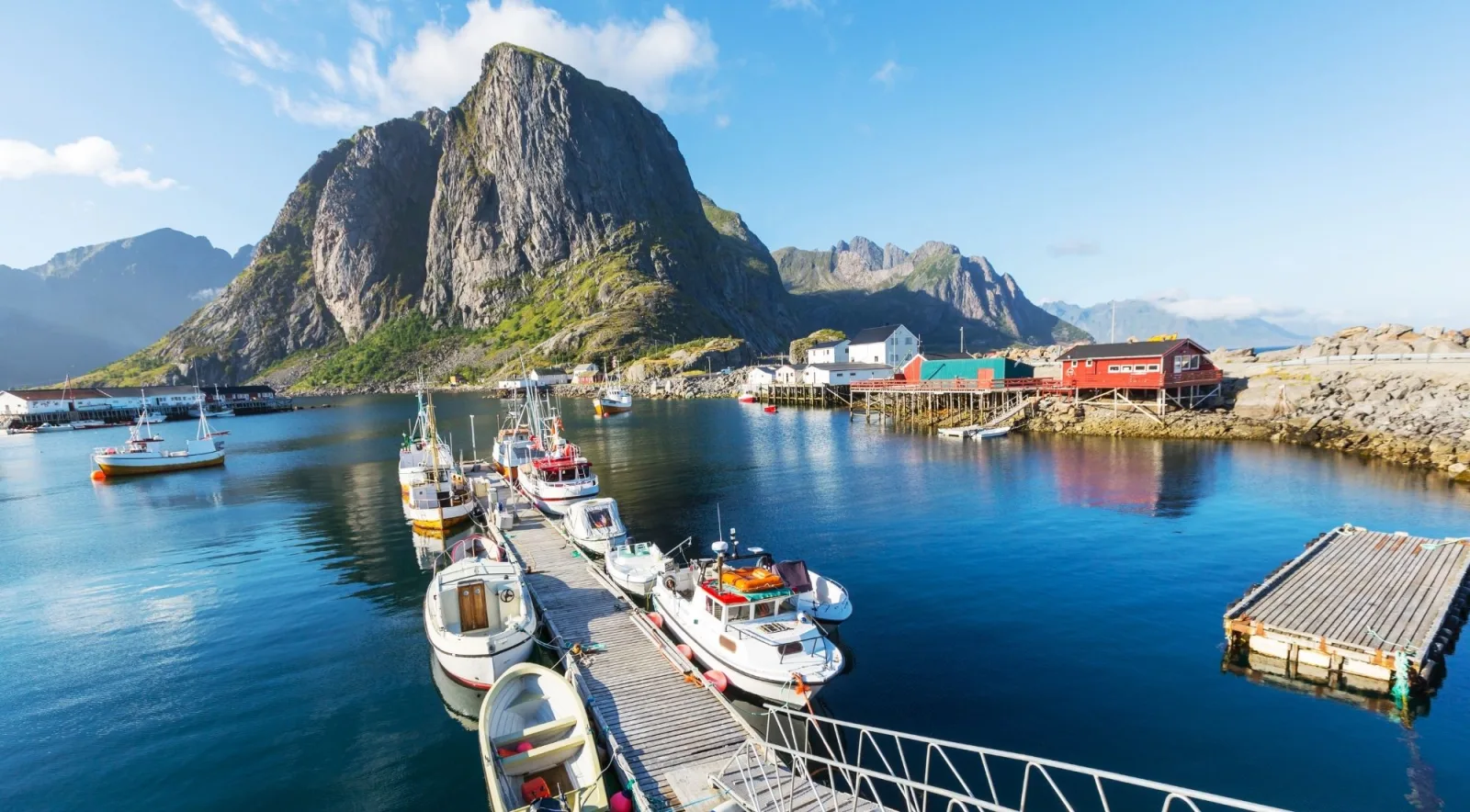 Fishing boats moored at Hamnoy beneath the iconic peak of Festhaeltinden